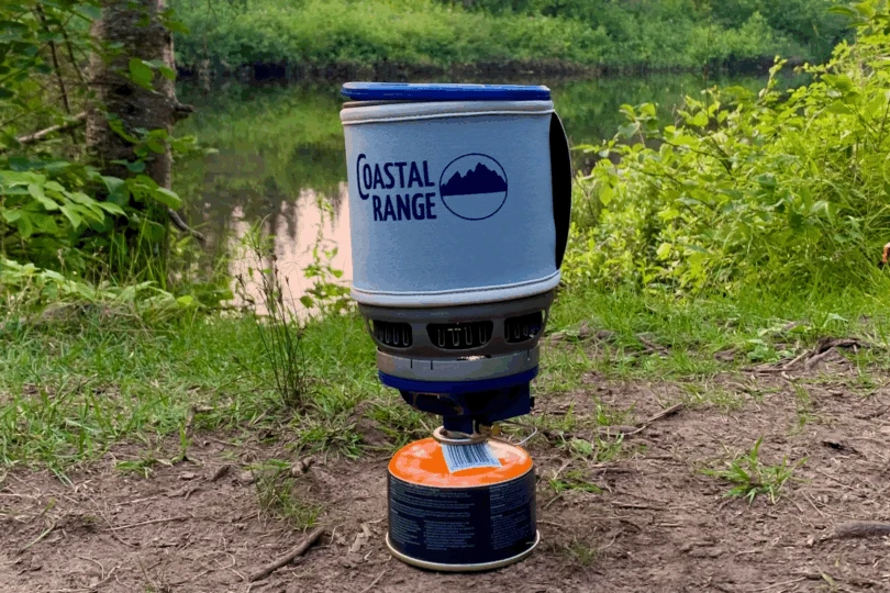 Stove set up with gas canister by river