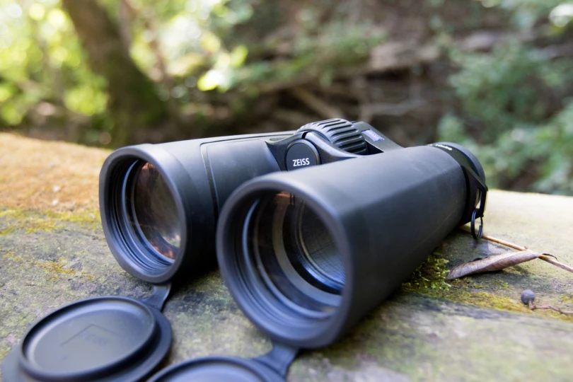 The ZEISS SFL 10X50 Binoculars on a log