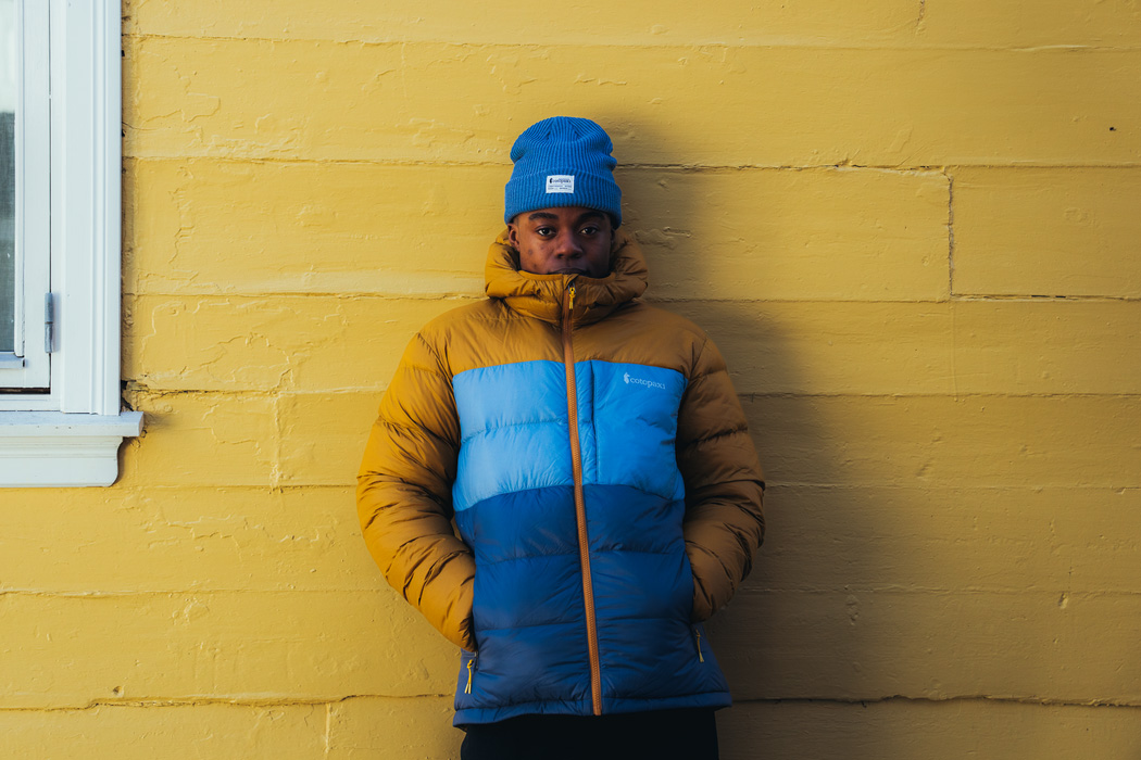 man standing in front of house in cotopaxi fuego max jacket