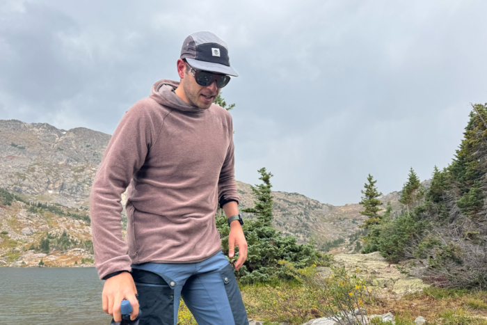 Man wearing a Mountain Hardwear Airmesh Hoody by the lake