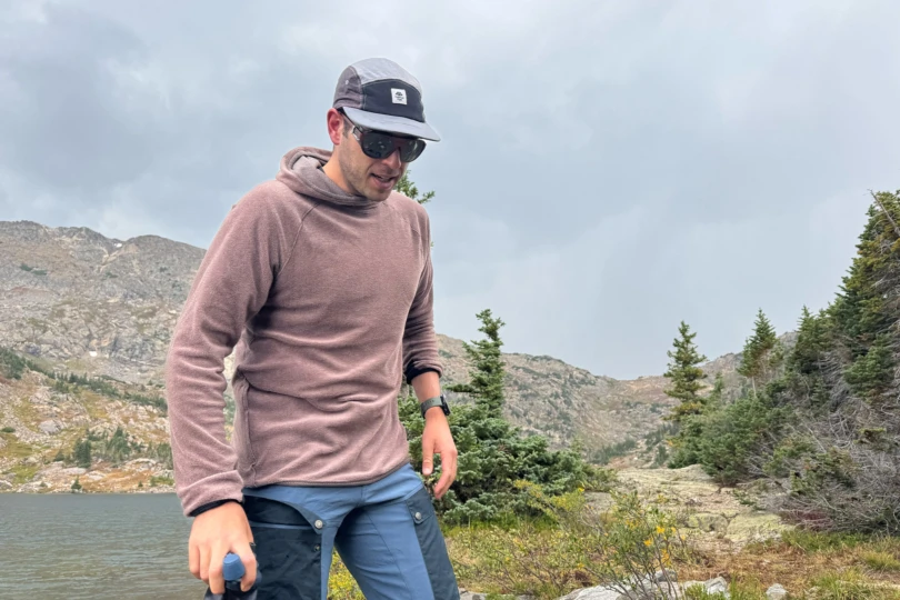 Man wearing a Mountain Hardwear Airmesh Hoody by the lake