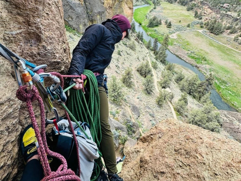the author leans back to set up a rappel while wearing the papsura shell
