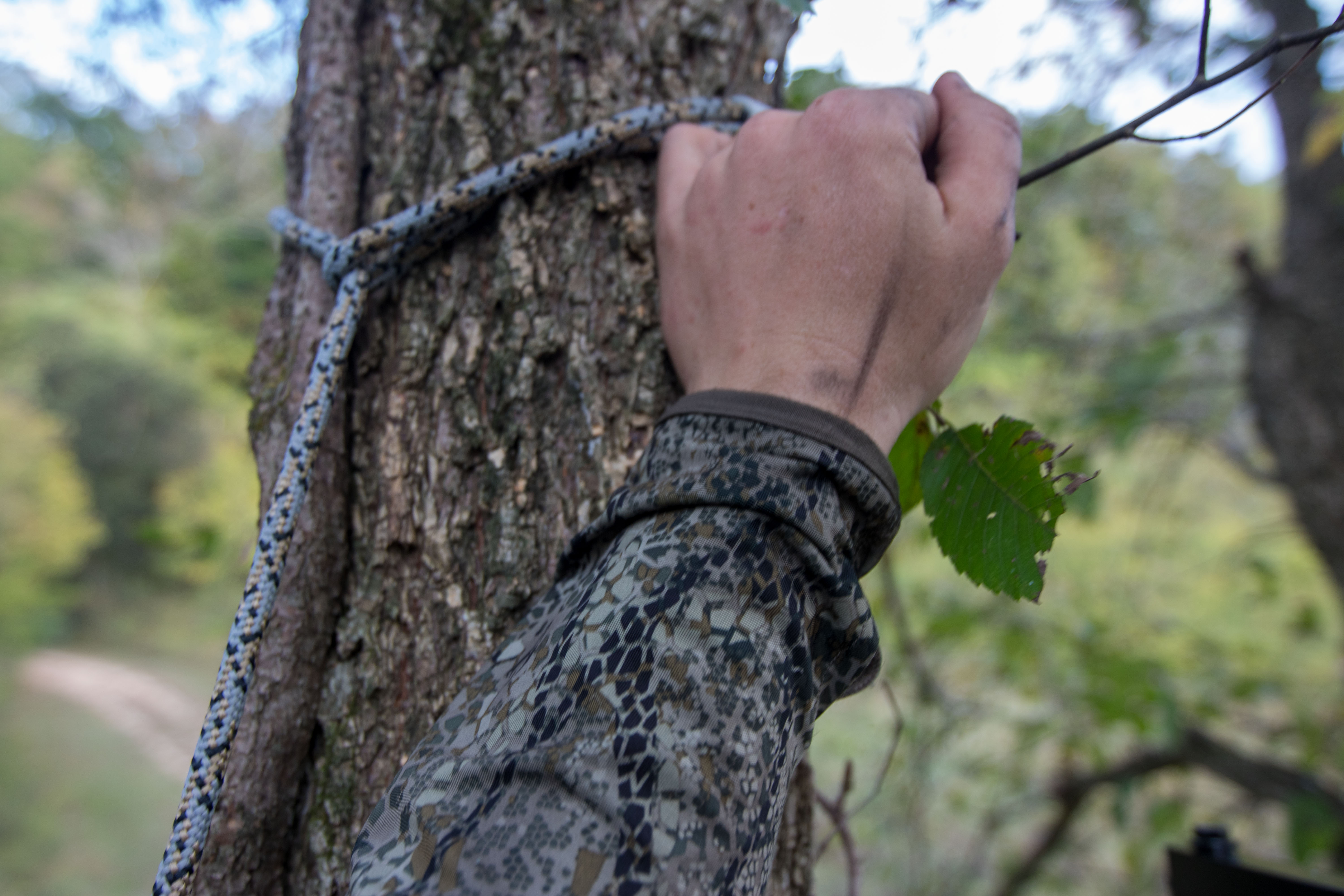 The sleeve of the Badlands Stealth CoolTouch hoody next to a tree
