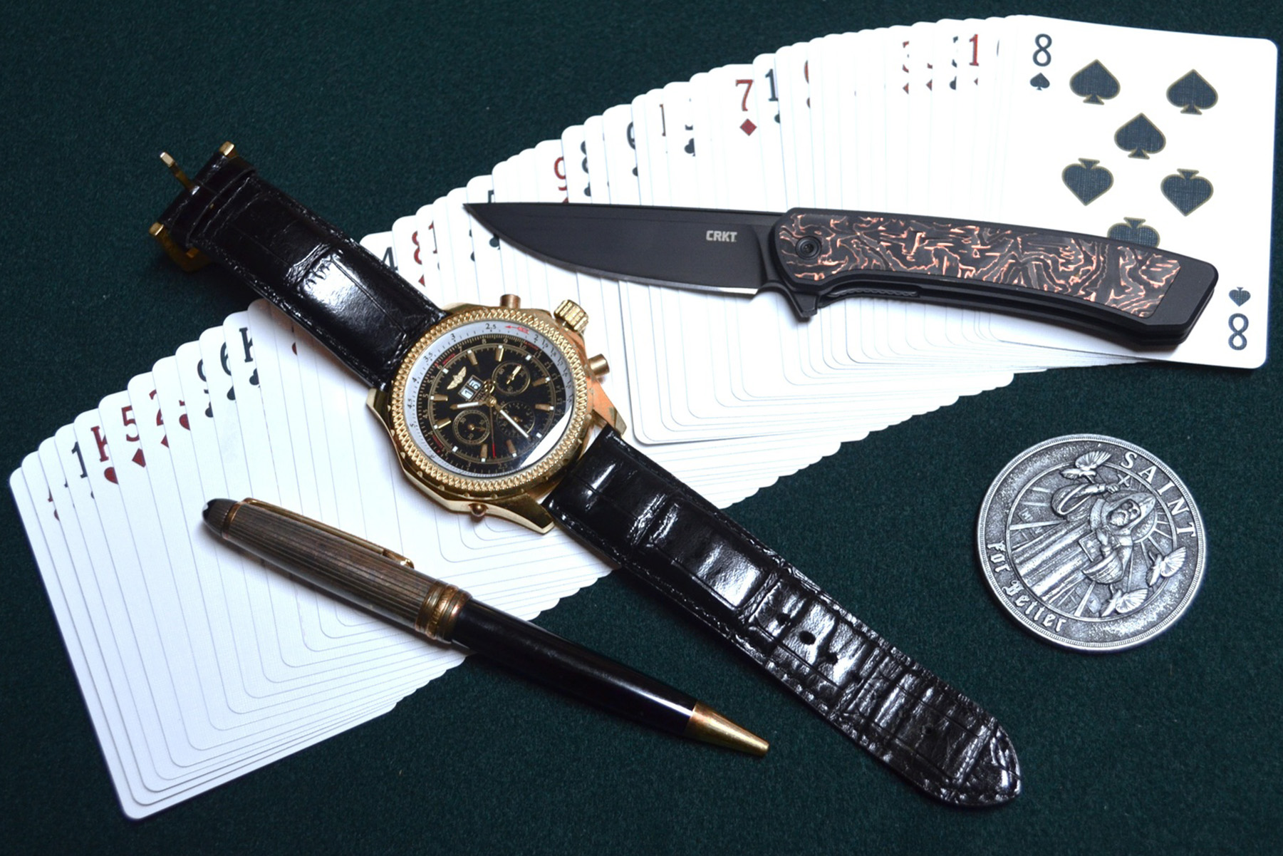 CRKT Q Compact Liner Lock shown open on a blue surface