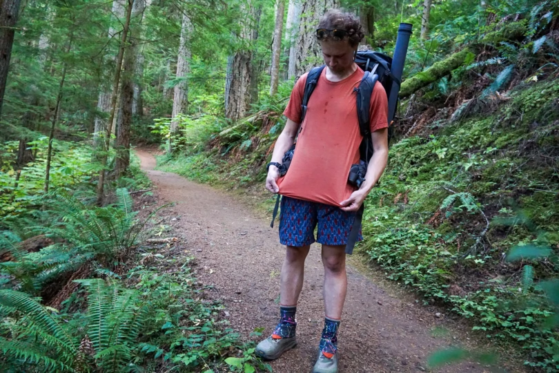 the author stretching out the merino tee while wearing it