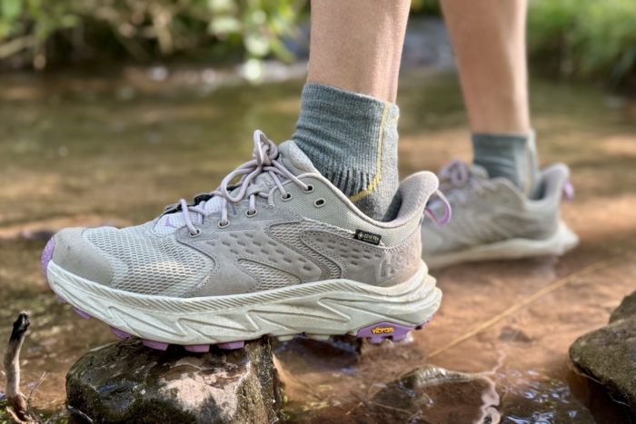 Woman wearing the Hoka Anacapa Low GTX hiking shoes on a hike