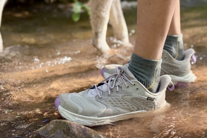 Woman wearing the Hoka Anacapa Low GTX in a stream