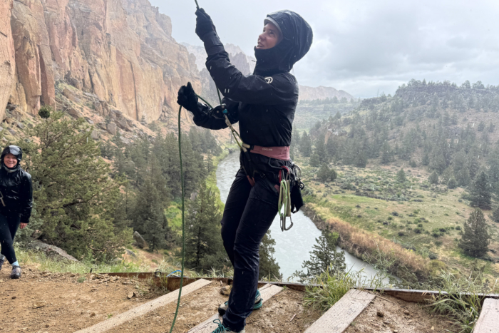 the author belays at smith rock state park while wearing the papsura jacket