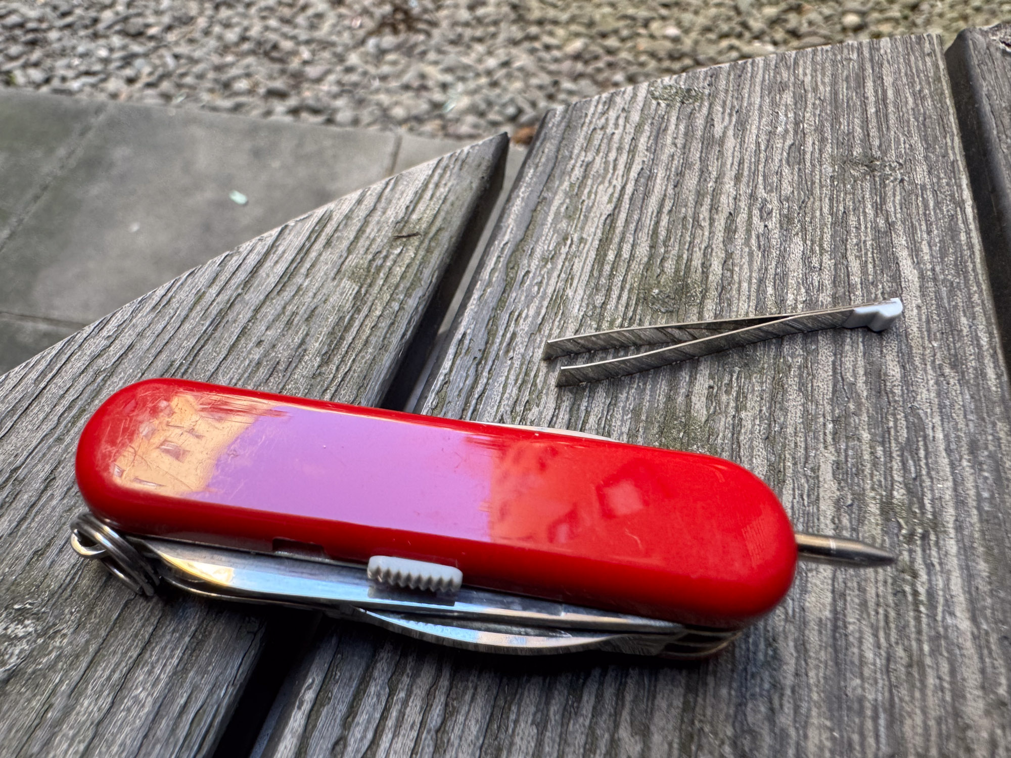 the mini champ tool detailing the ballpoint pen that retracts into one of the scales