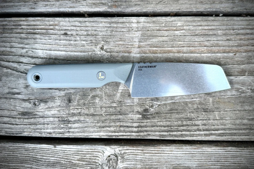 Close-up of Leatherman Rustle on a weathered wooden surface