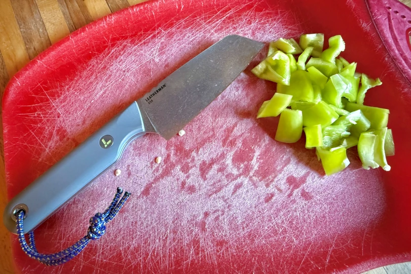 Leatherman Rustle beside chopped peppers on a red cutting board