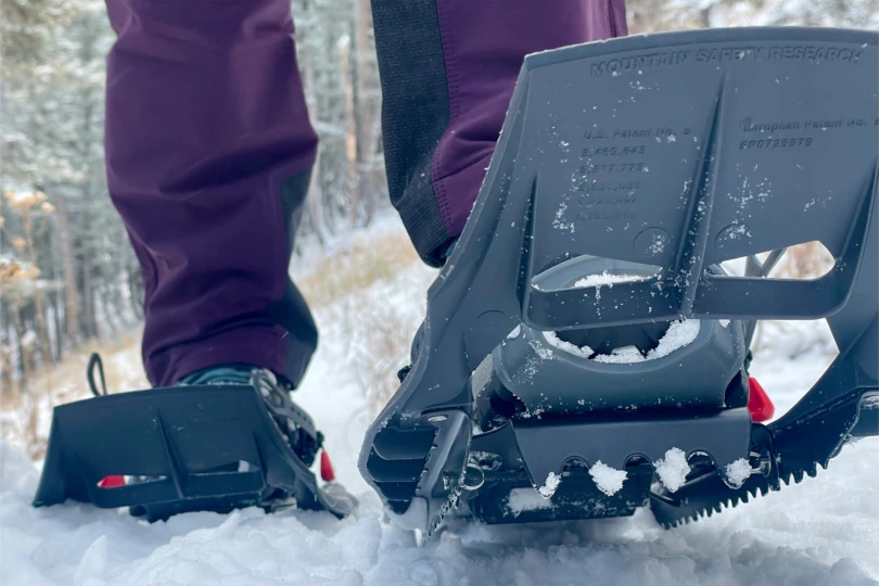 The MSR Evo Trail snowshoes grip packed snow on a forest trail