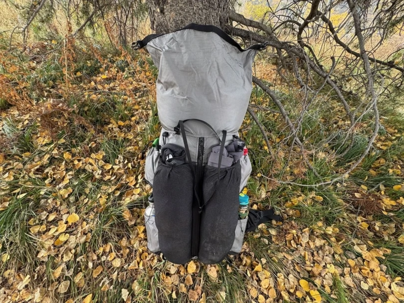 Outdoor Vitals Shadowlight 60 standing under a tree, fully packed and ready for the trail