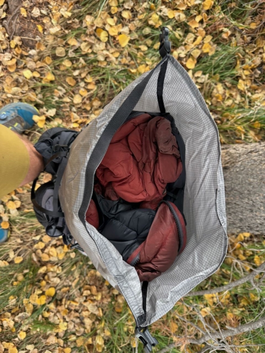 Looking inside the Outdoor Vitals Shadowlight 60 shows a spacious main compartment packed with insulated gear