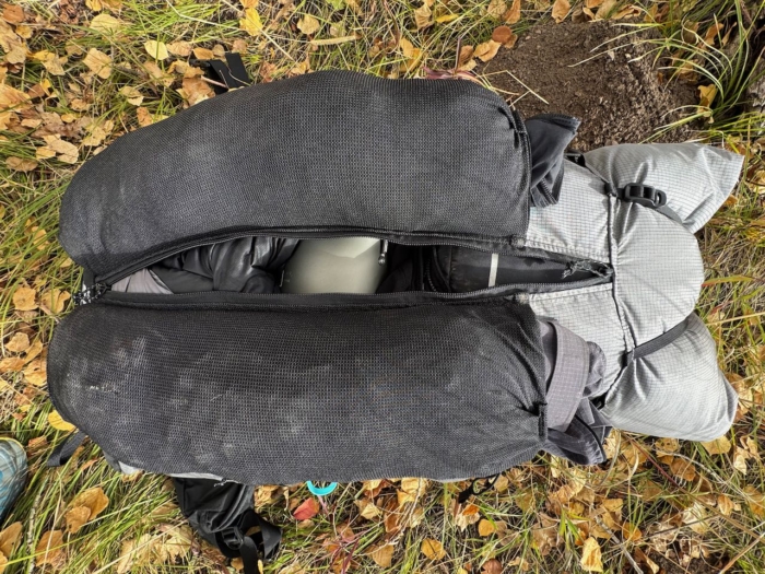 Top-down look into the Outdoor Vitals Shadowlight 60 mesh front pockets filled with packed gear