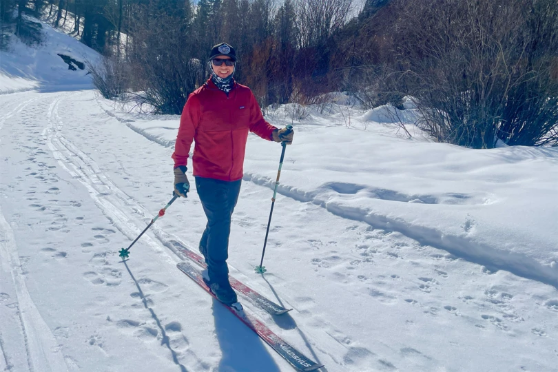 Cross-country skiing on a sunny winter day in red fleece