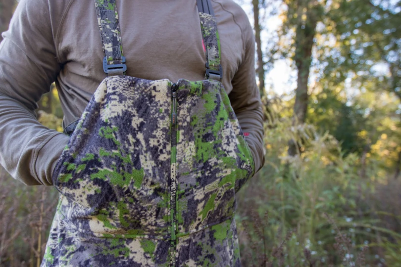 A hunter with their hand in the pockets of the SITKA Stratus 2.0 bibs