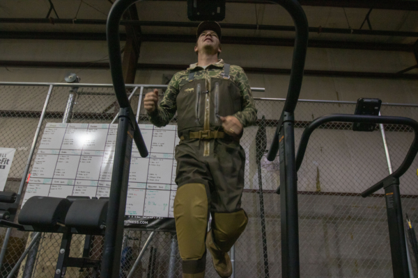 A man running on a treadmill in the SITKA Delta Ventlite Zip GTX Waders