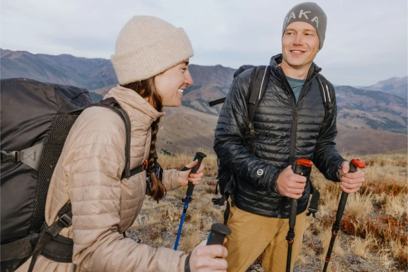 Two backpackers wearing puffy jackets
