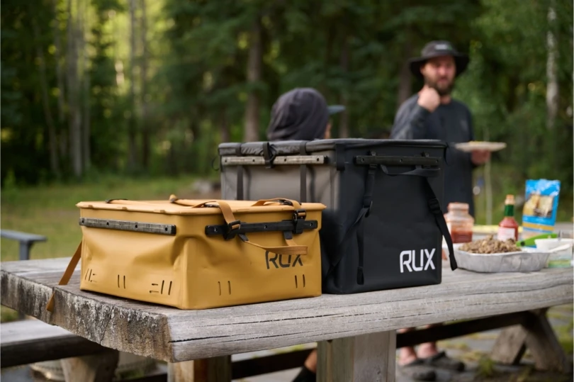 Two storage backs on picnic table at campground