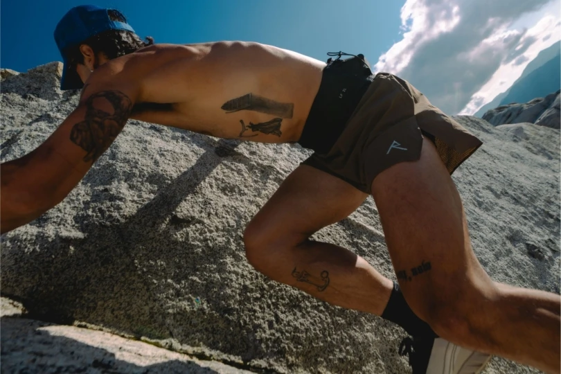 Close up of trail runner scrambling rocks