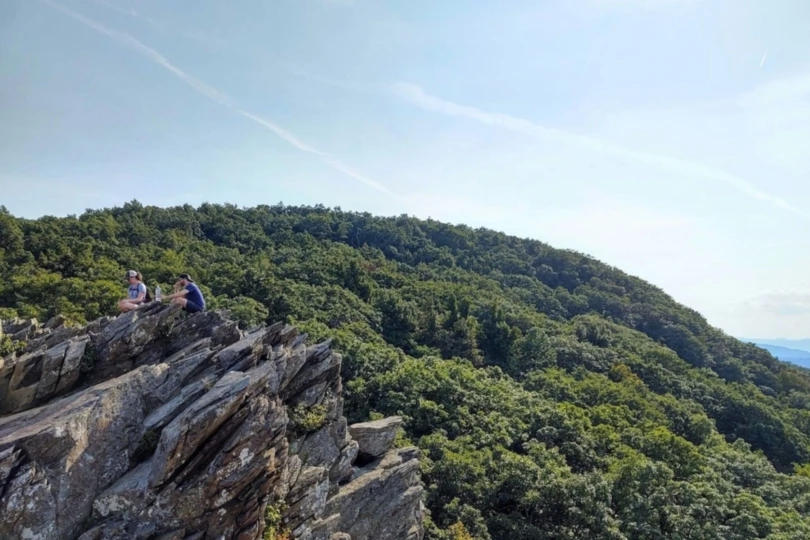 people sit on rock formation