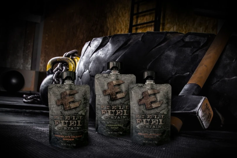 Three food pouches with tire and sledgehammer in background