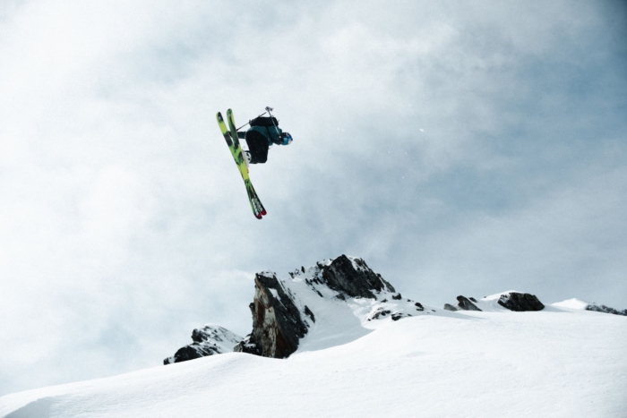 Skier jumps on snowy mountain