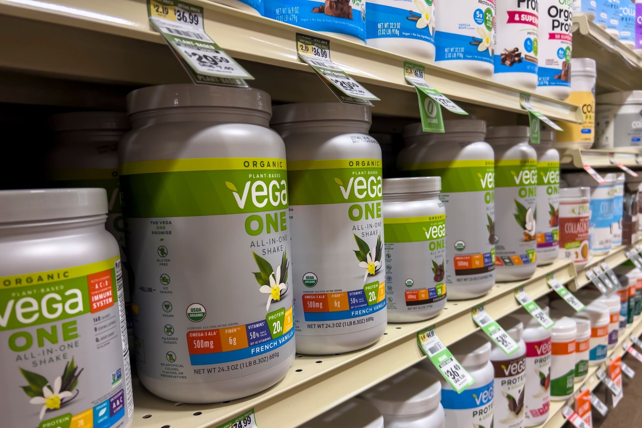 Protein powders on a shelf in the grocery store