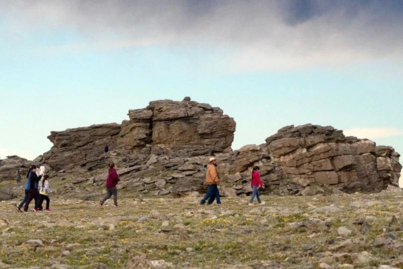Hikers in front of rock formation