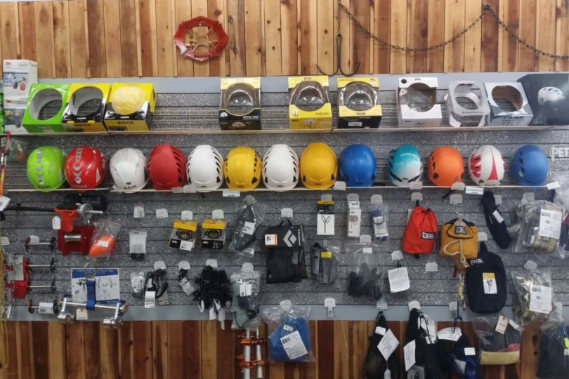Climbing helmets and other gear on shelves