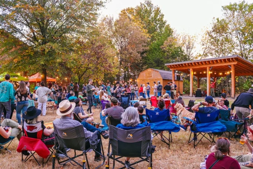 People gather outside in lawn chairs