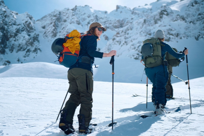 People hike up snowy mountain