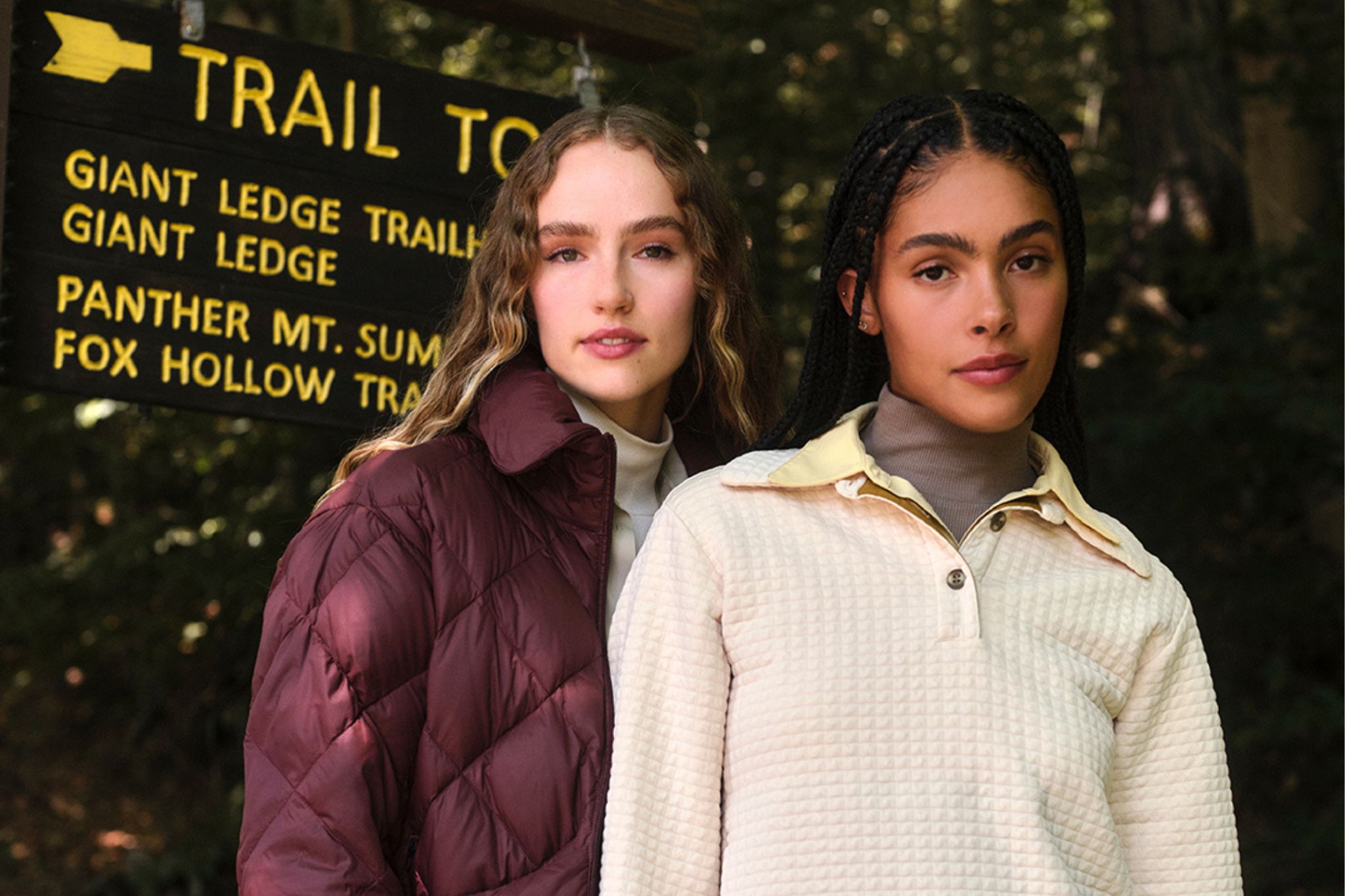 Close up shot of women outside by trail sign