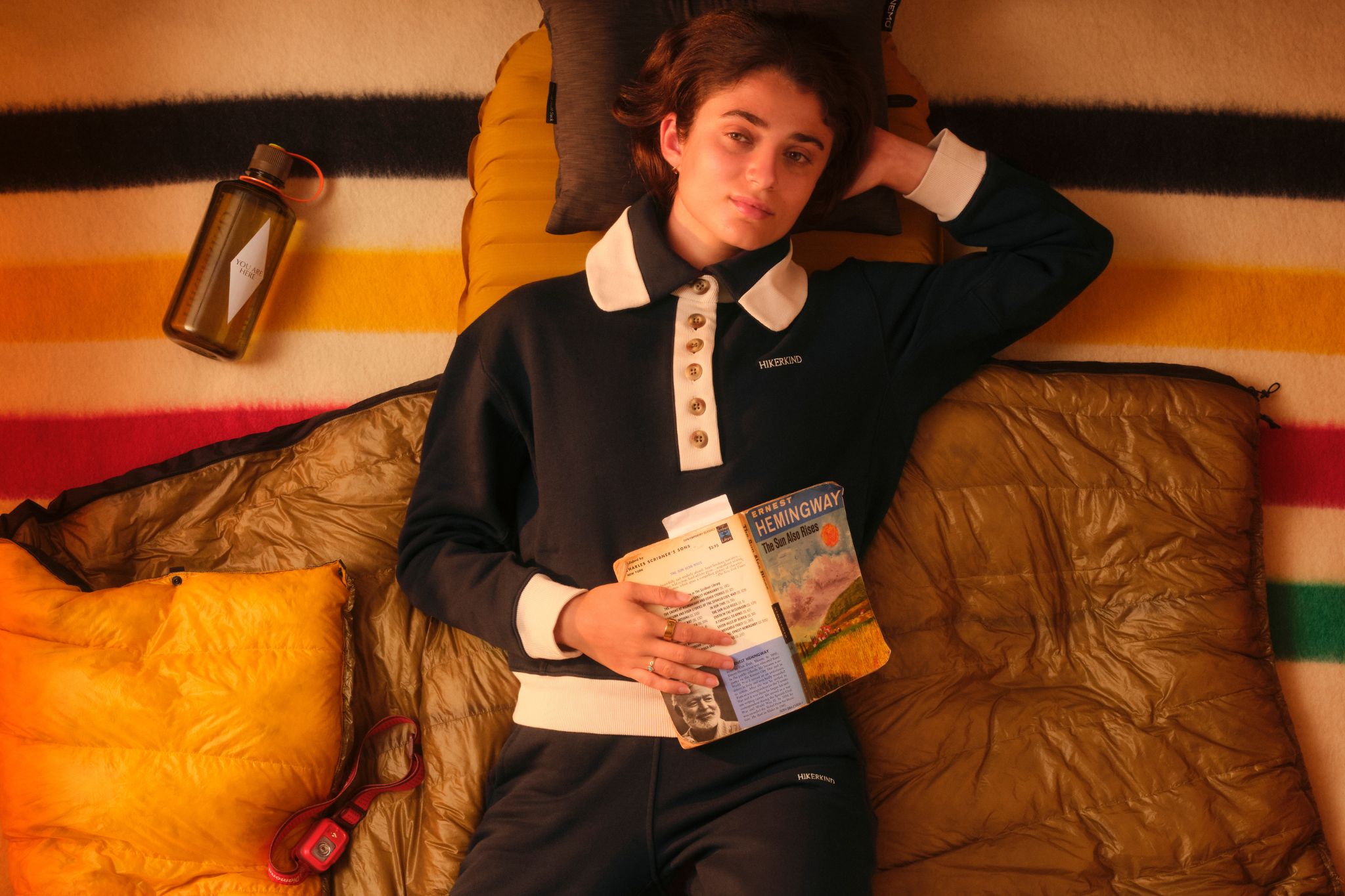 person lays on bed in pajamas