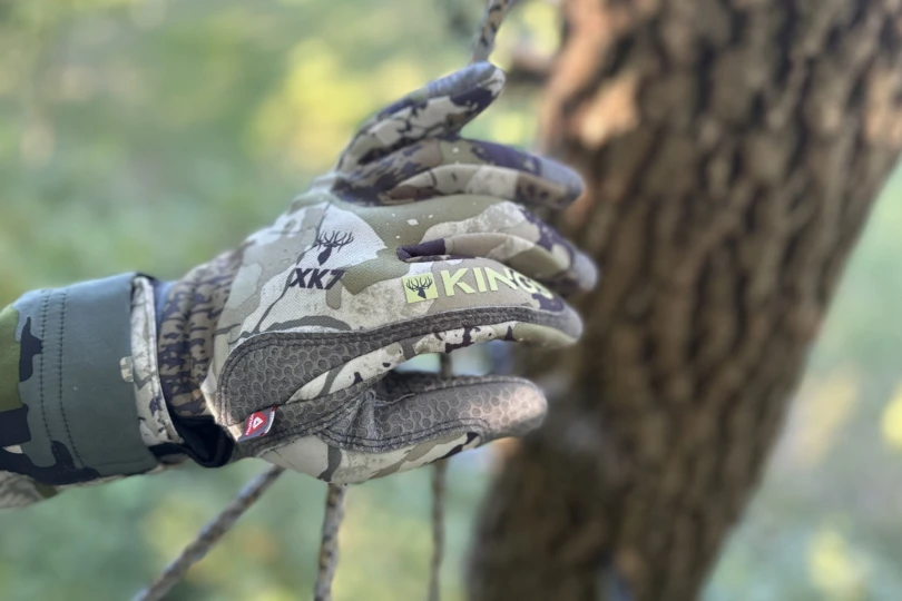 A gloved hand on a rope.