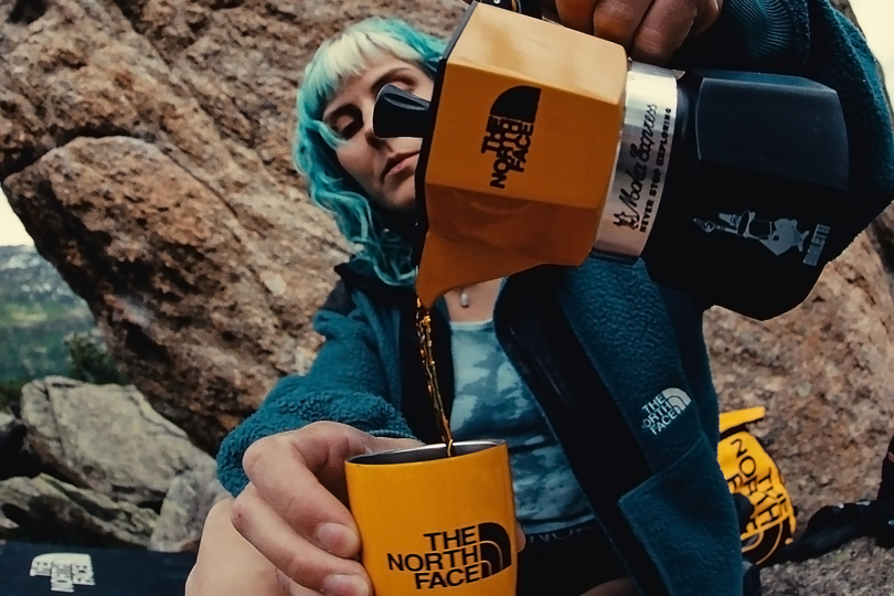 woman pouring coffee from the north face moka pot