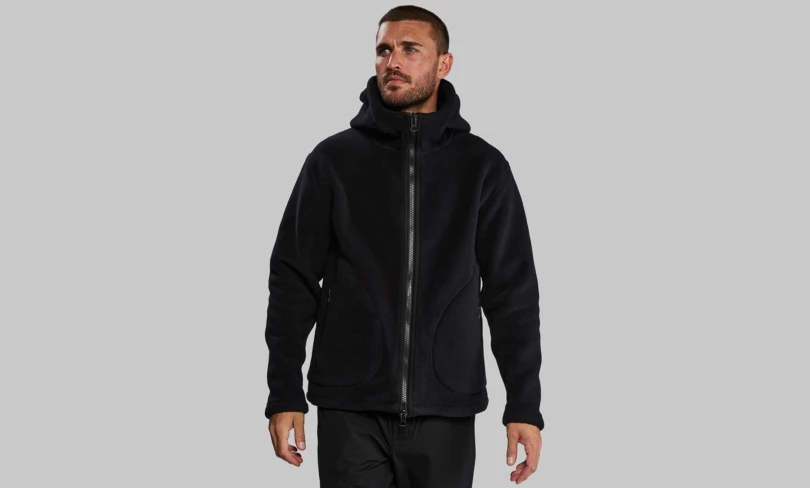 Man stands wearing black fleece jacket