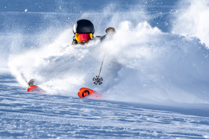A skier charges through deep powder, the Blizzard Zero G 96 slicing cleanly through snow spray