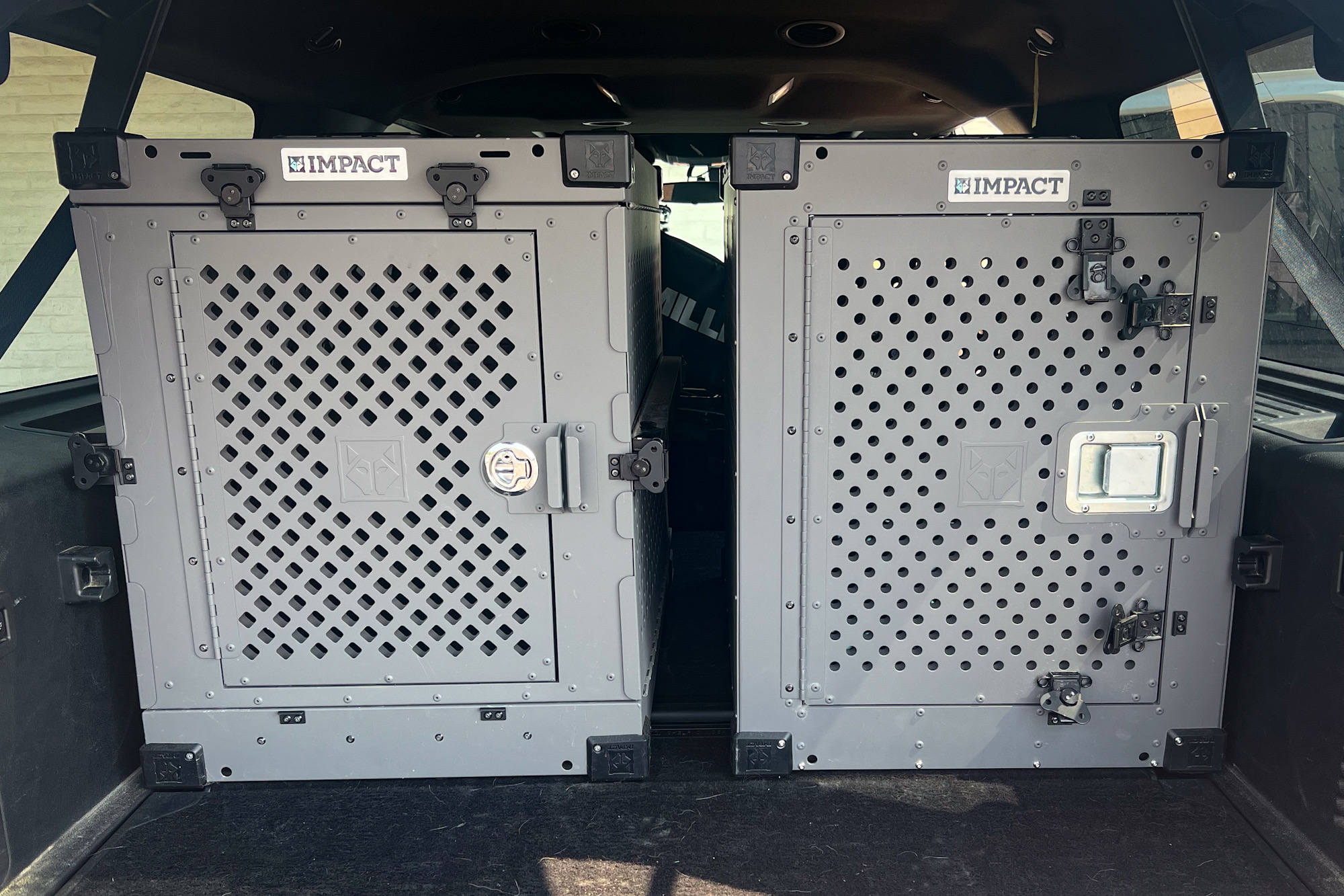 two impact dog crates in back of suv