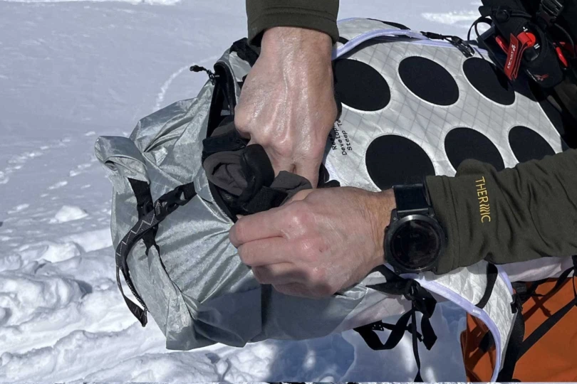 A cheater pocket sits behind the neck and above the back-panel zipper. It's great for accessing gloves on the go. Note the integrated pod-like cushions on the back panel; (photo/Steve Graepel)