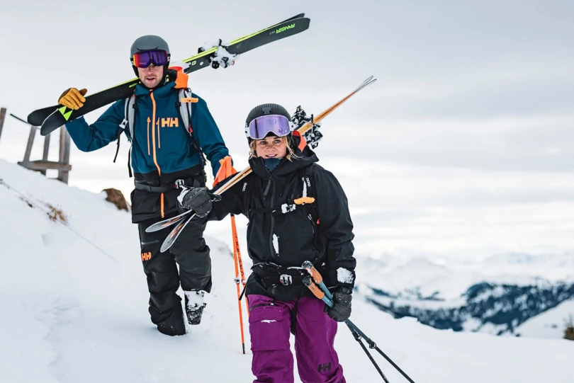 Helly Hansen skiers walking with skis
