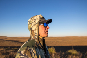 The hood of the Kings Camo XKG Pinnacle Jacket on an upland hunters head.