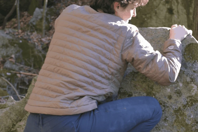 Person climbs up rock