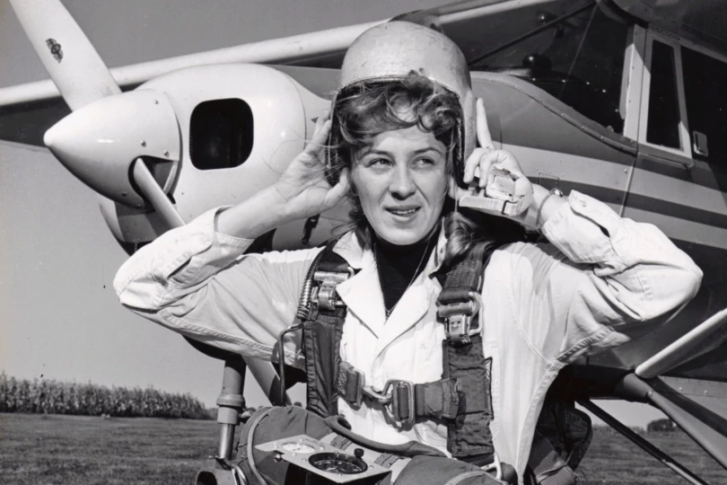 Black and white photo of a woman getting ready for skydiving