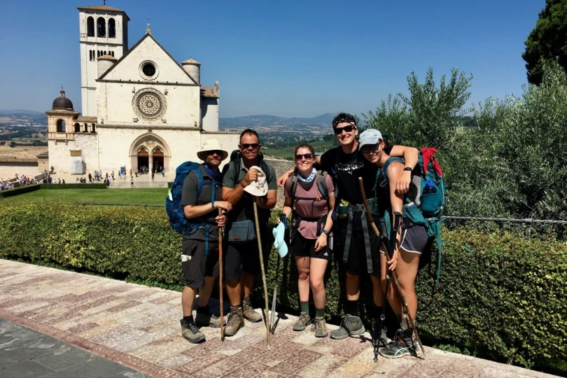 A group of hikers in front of a church