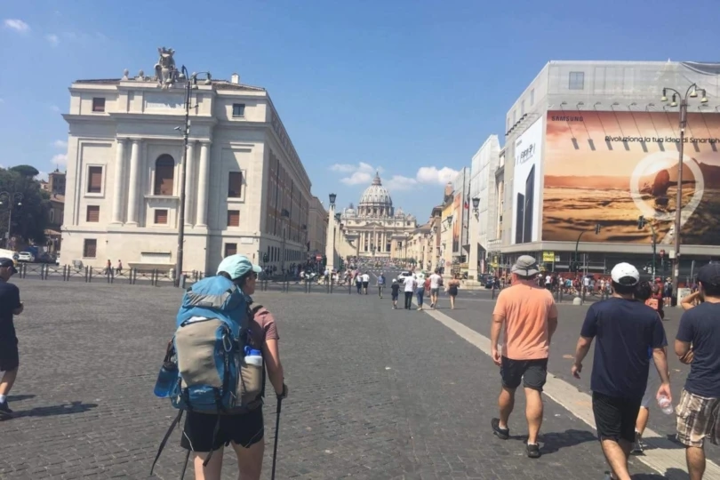 Hiker on streets of Rome toward St. Peter's