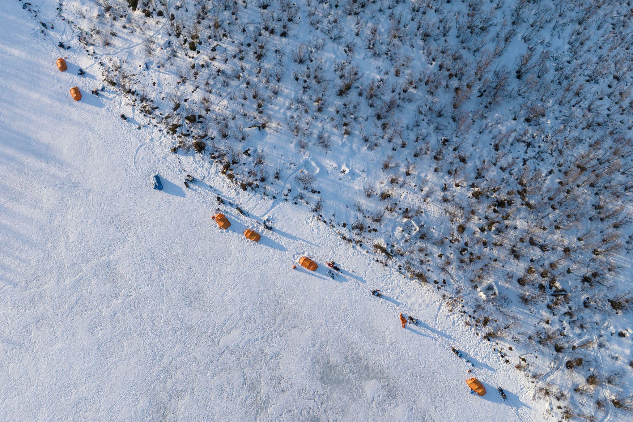 View from above of camp on snow with tents