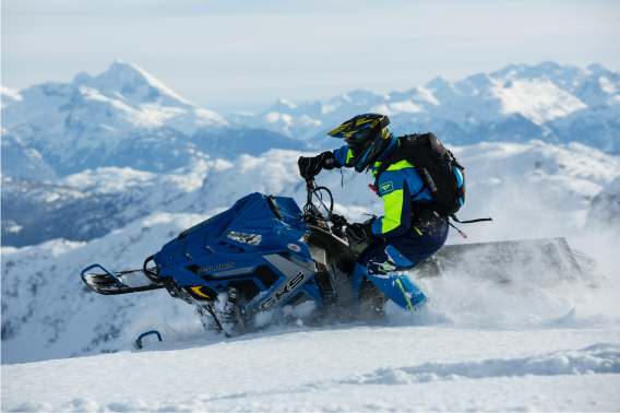 Person riding snowmobile turns