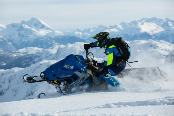 Person riding snowmobile turns